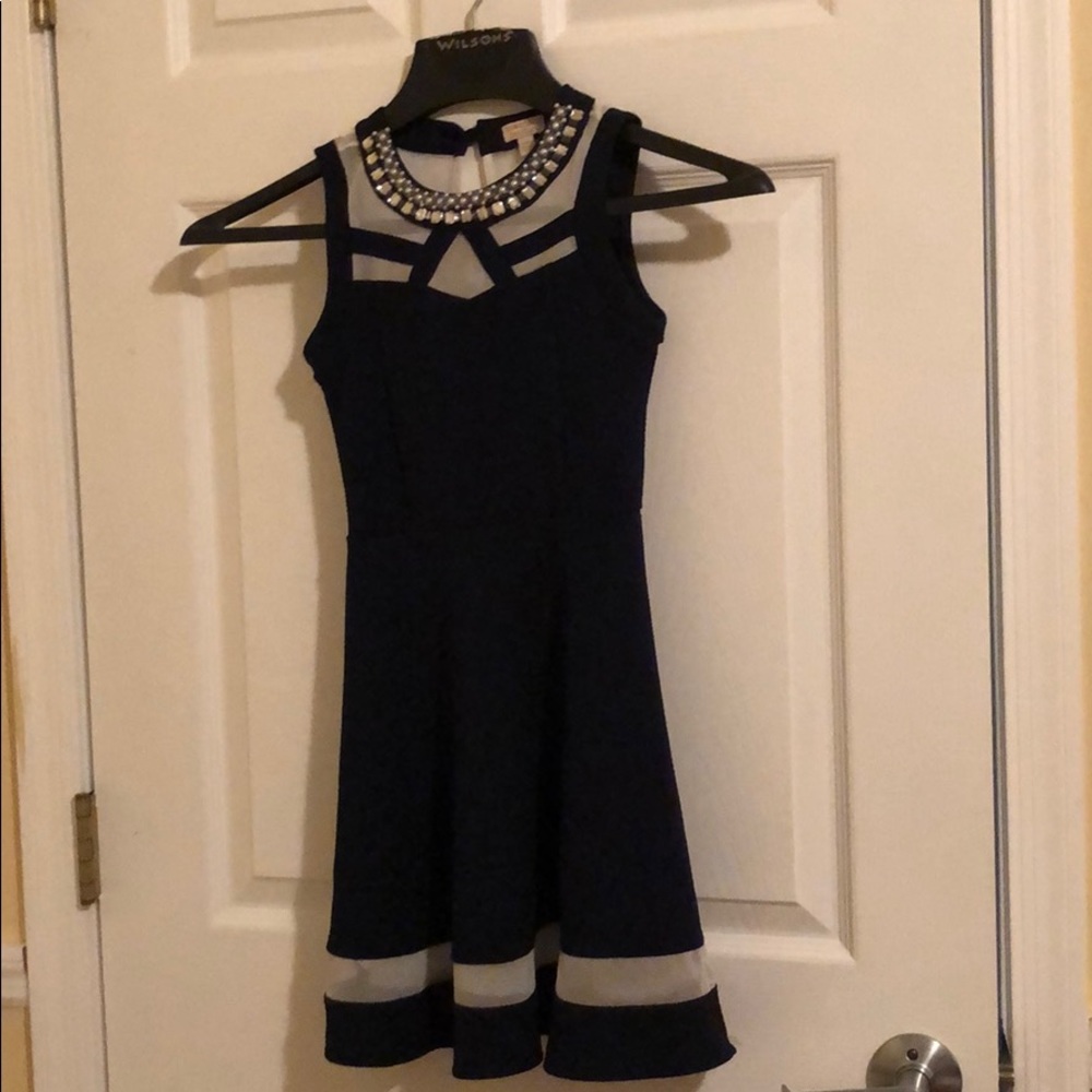Monteau Couture with rhinestone around the collar.